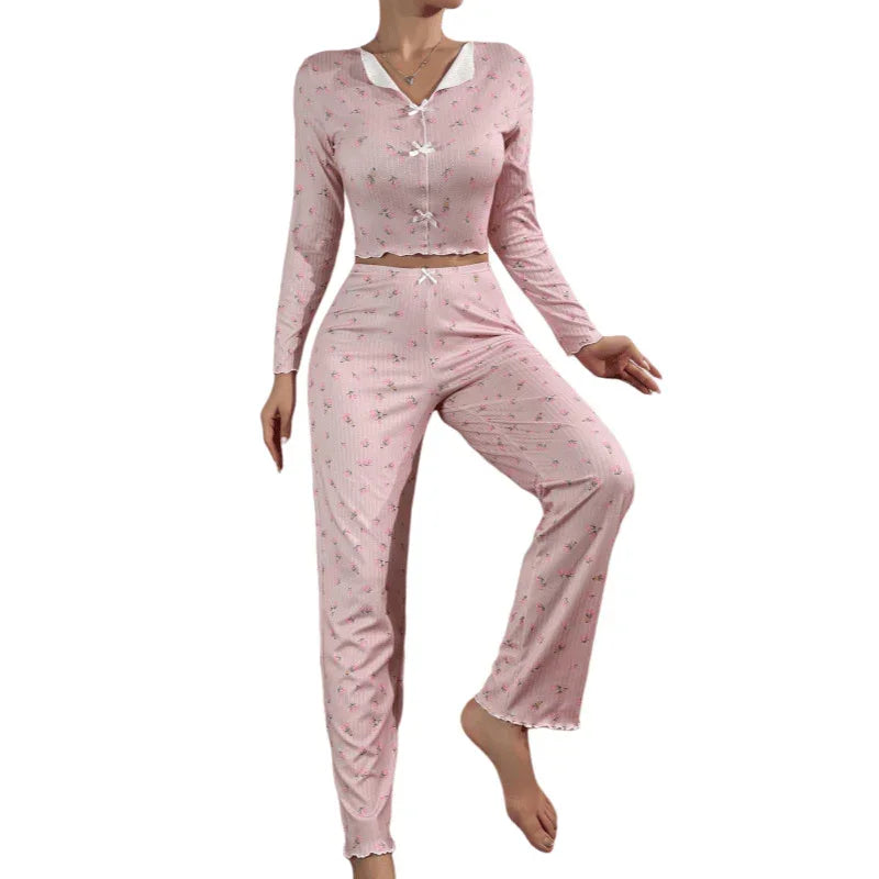 Woman wearing pink floral long-sleeve pajama set with ribbed texture and bow details