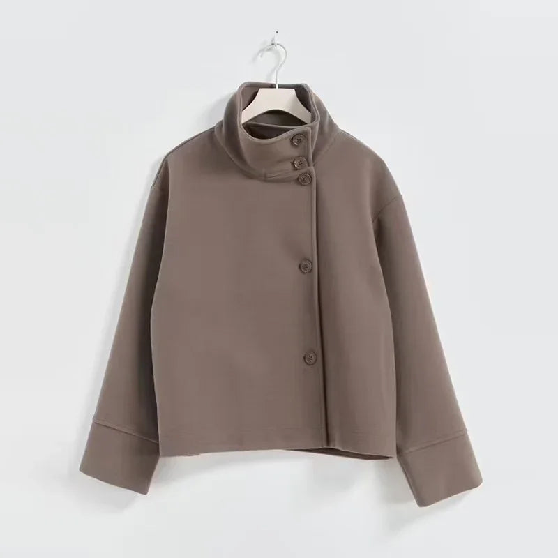 brown high-neck buttoned jacket with long sleeves hanging on white hanger