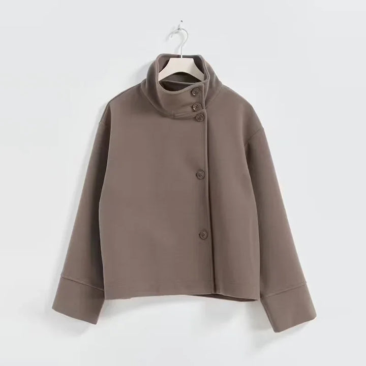 brown high-neck buttoned jacket with long sleeves hanging on white hanger