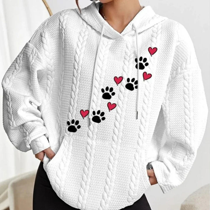 White cable knit hoodie with black paw prints and red hearts design on front