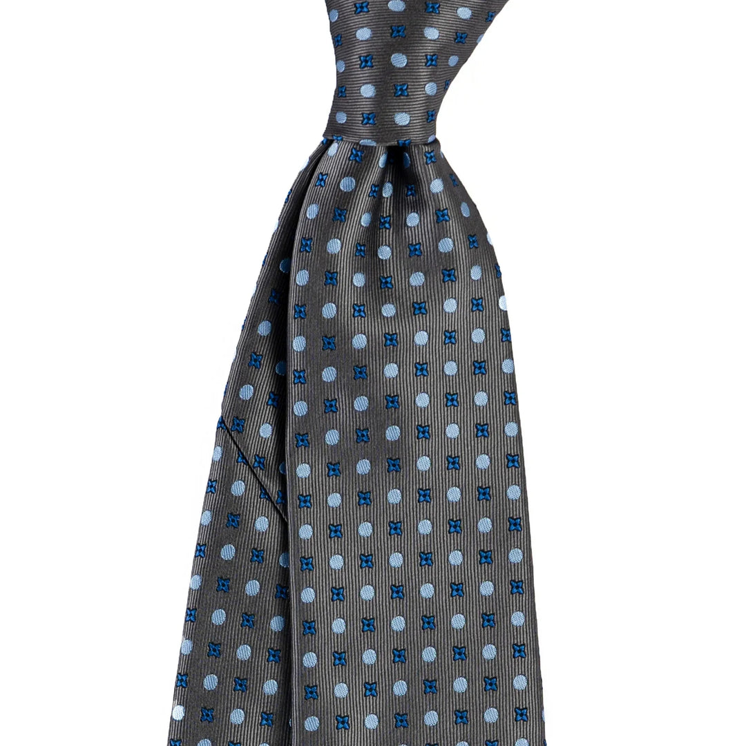 Grey silk necktie with blue polka dots and small cross patterns on white background