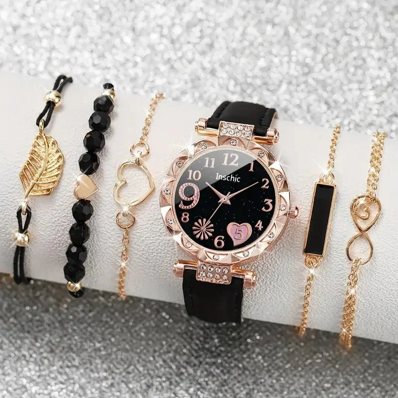 Black dial wristwatch with rose gold bezel and five gold-tone bracelets with black and heart accents