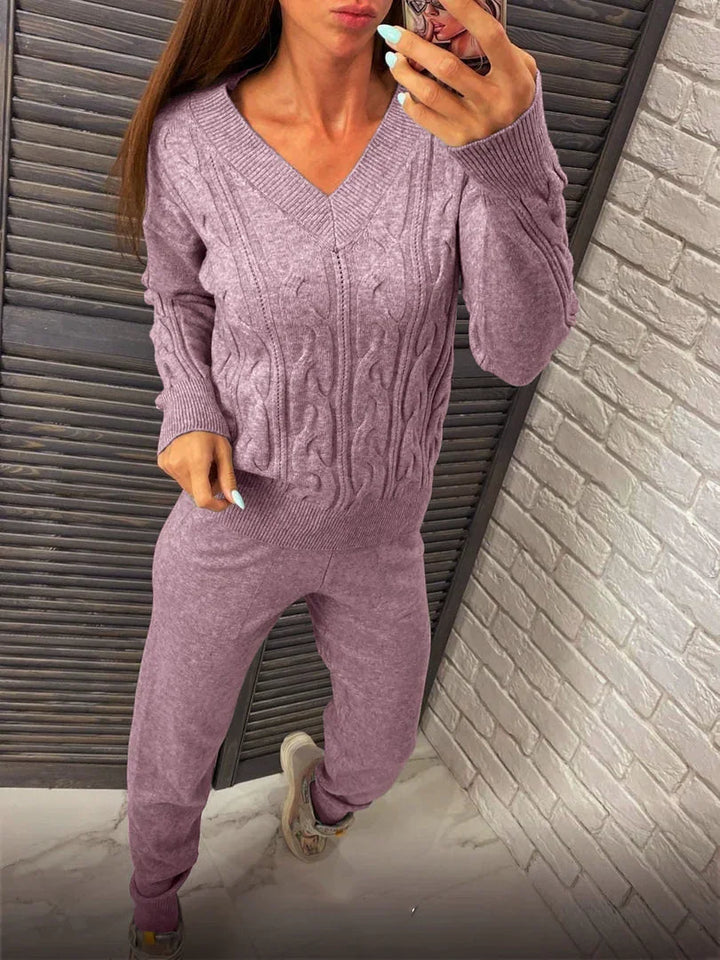 Woman wearing a cozy lavender cable knit sweater and matching jogger pants outfit indoors