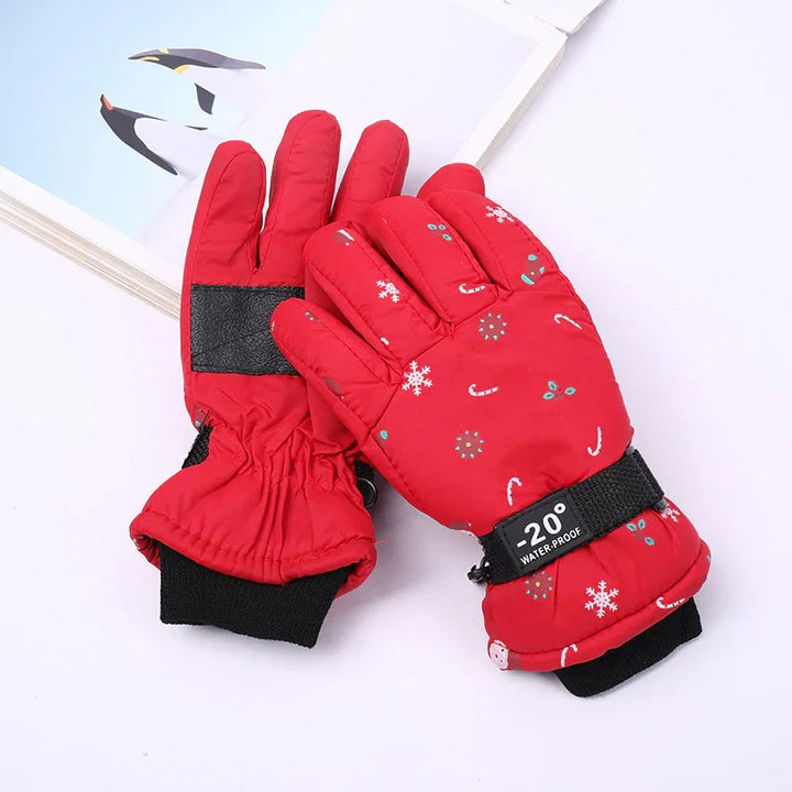 Red waterproof winter gloves with snowflake and candy cane patterns, adjustable strap, and black wrist cuffs