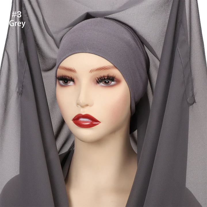 Mannequin head wearing grey inner cap and matching grey sheer hijab fabric