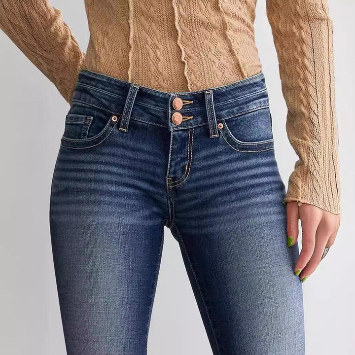 Close-up of blue high-waisted skinny jeans with double button and beige cable knit sweater