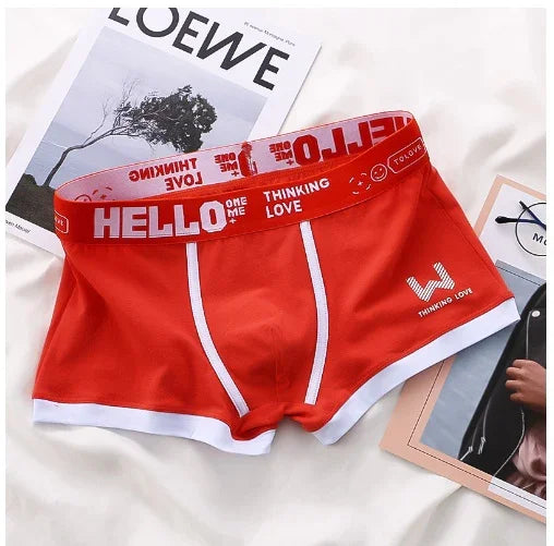 Red men's boxer briefs with white trim and elastic waistband printed with HELLO and THINKING LOVE text