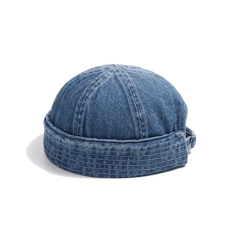 Blue denim cap with rolled brim and adjustable strap on white background