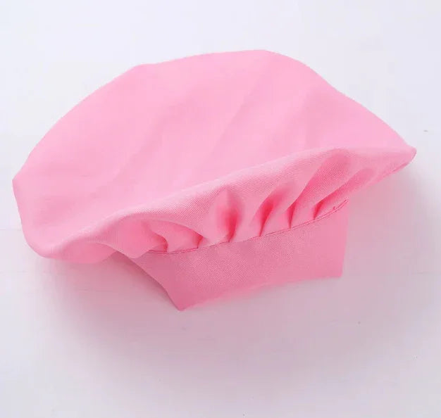 Soft pink beret hat with gathered fabric detail on a white background