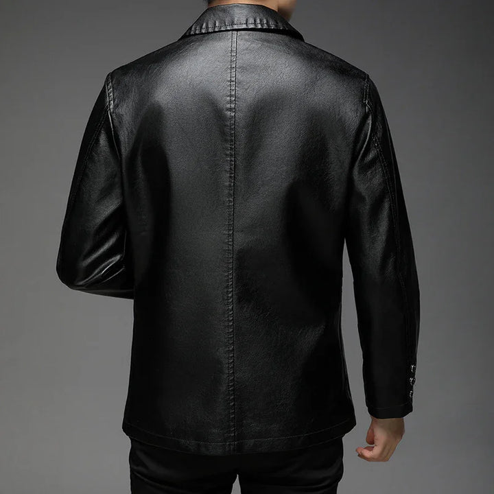 Back view of a man wearing a black leather jacket with long sleeves against a gray background