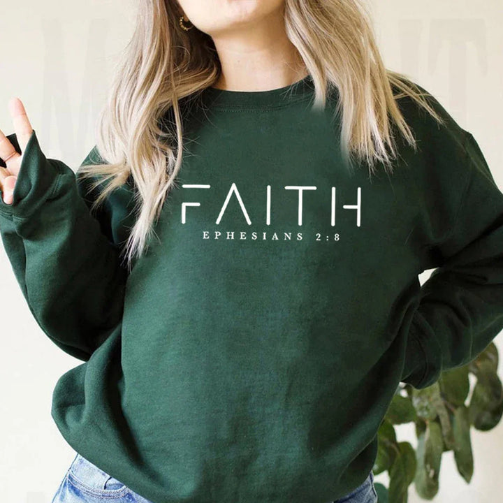 Woman wearing dark green sweatshirt with faith and Ephesians 2:8 Christian scripture text