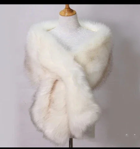 White faux fur shawl draped on dress form against light gray background