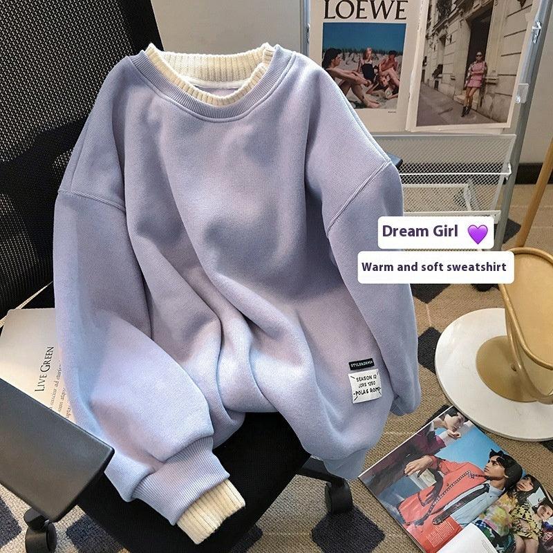 Lavender warm and soft sweatshirt with ribbed cuffs on chair, fashion magazines and decor in background