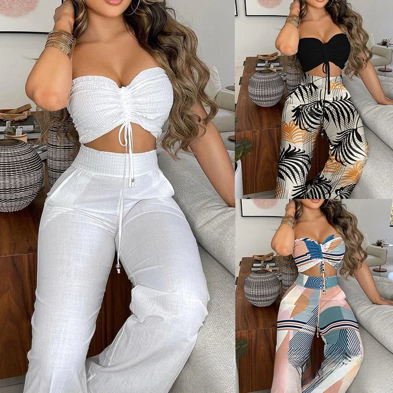 Woman modeling three sets of strapless crop tops with high-waisted pants in white, black leaf print, and colorful geometric designs