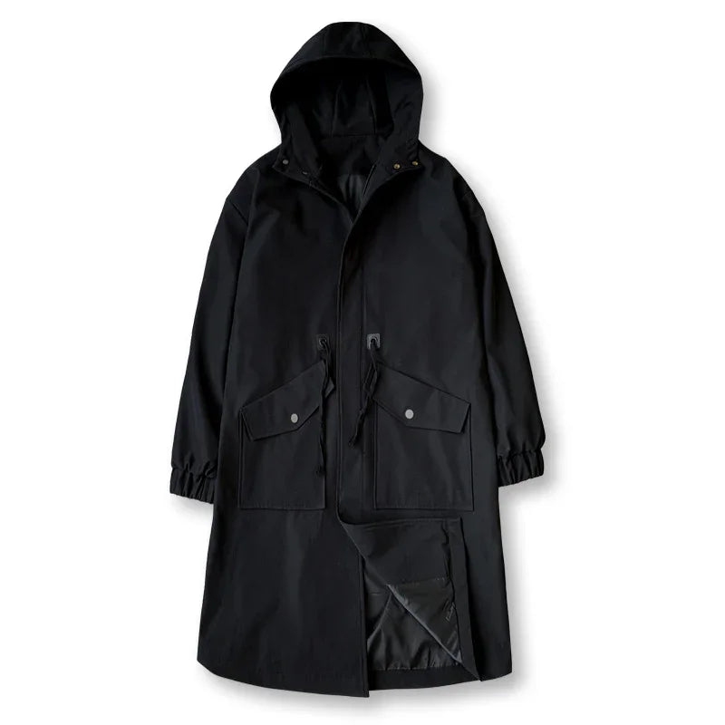 Black long hooded raincoat with front flap pockets and drawstring waist on white background