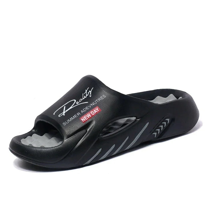 Black unisex slide sandal with padded sole and "Roadtrip Summer Adventures New Day" text