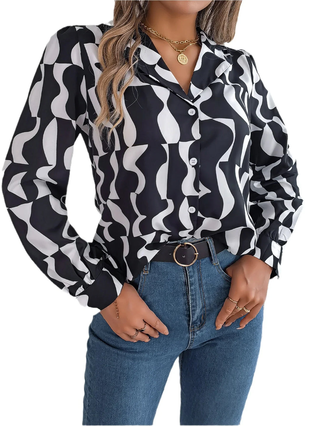 Woman wearing black and white abstract pattern button-up blouse with blue jeans and black belt