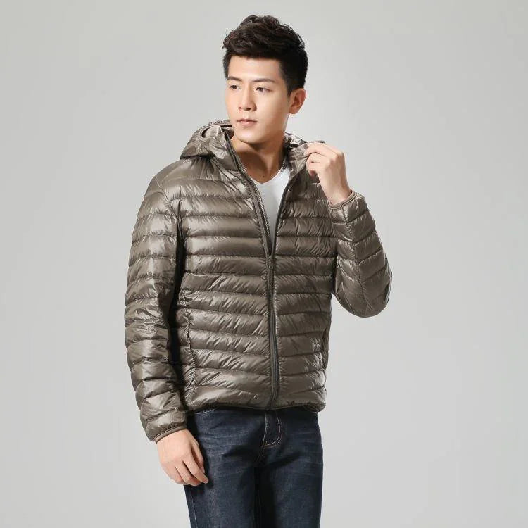 Man wearing shiny brown hooded puffer jacket with zipper, styling casual winter outerwear