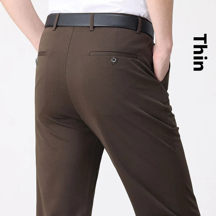 Rear view of person wearing slim-fit brown dress pants with black belt and white shirt