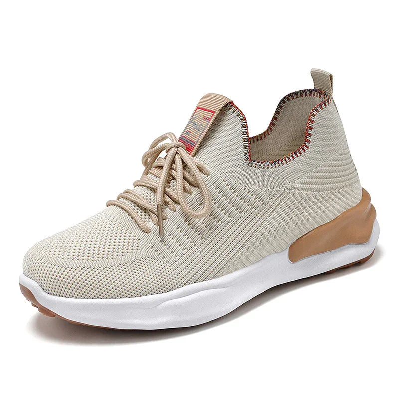 Beige knit fabric sneaker with white sole and brown accents, lace-up design, and pull tabs