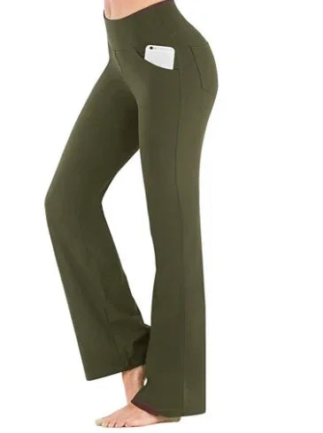 Olive green yoga pants with high waist and side pocket holding a white smartphone, worn barefoot