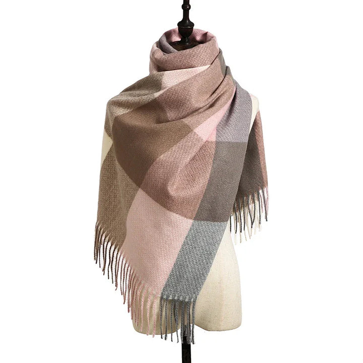 Soft plaid scarf with beige, pink, brown, and gray tones on mannequin with fringed edges