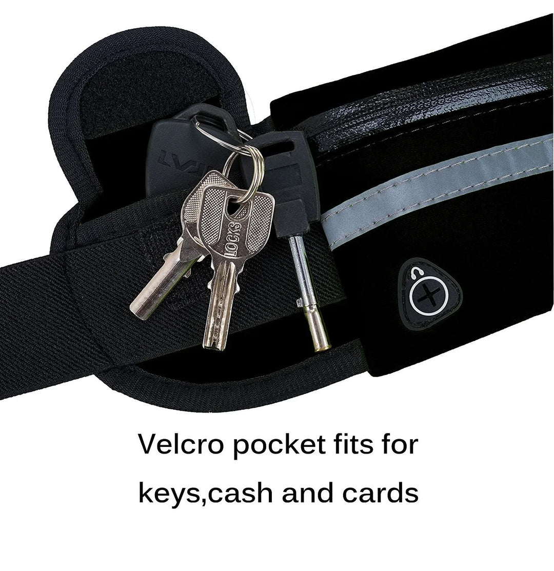 Black Velcro pocket on a running belt holding keys, cash, and cards with reflective strip