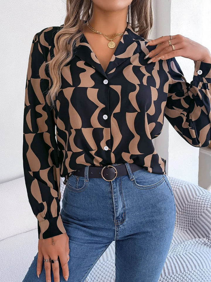 Woman wearing black and brown abstract print button-up blouse paired with blue jeans and a black belt