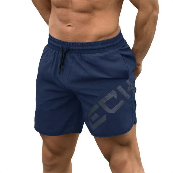 Man wearing navy blue athletic shorts with drawstring and side logo, fitness apparel