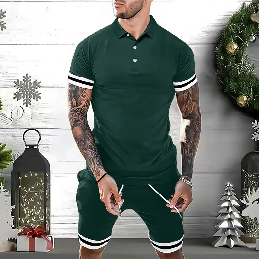 Man wearing dark green polo shirt and shorts with white stripes, Christmas wreath and decorations background
