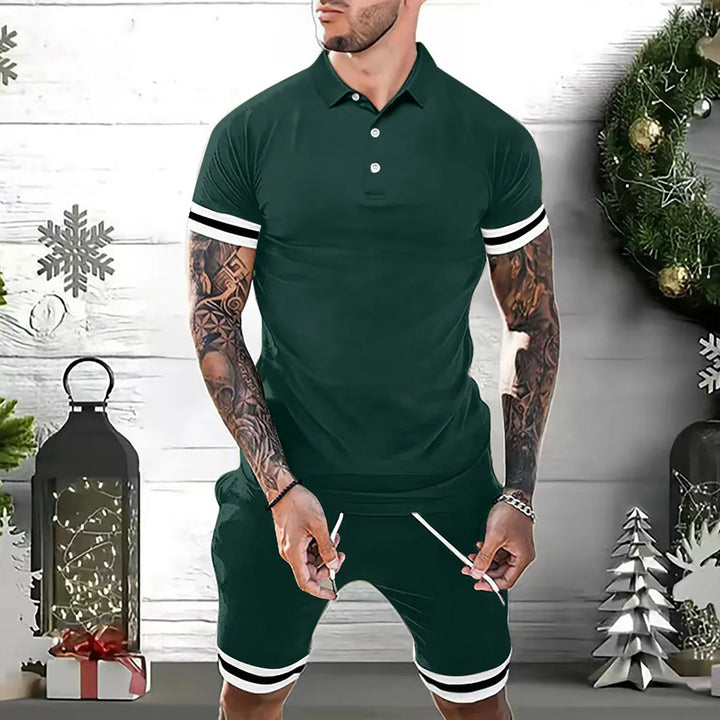 Man wearing dark green polo shirt and shorts with white stripes, Christmas wreath and decorations background