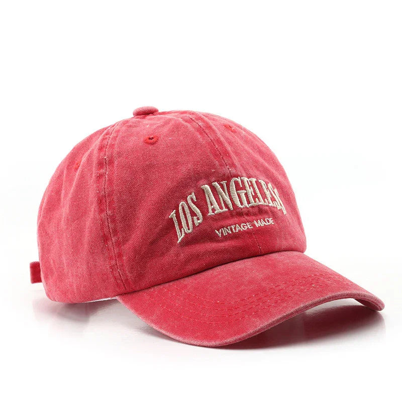 Red vintage baseball cap with white embroidered text 'LOS ANGELES VINTAGE MADE' on front
