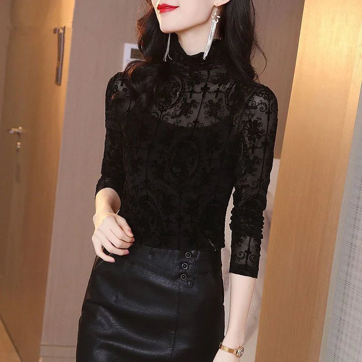Woman wearing a black lace turtleneck top and black leather skirt with gold watch and long earrings