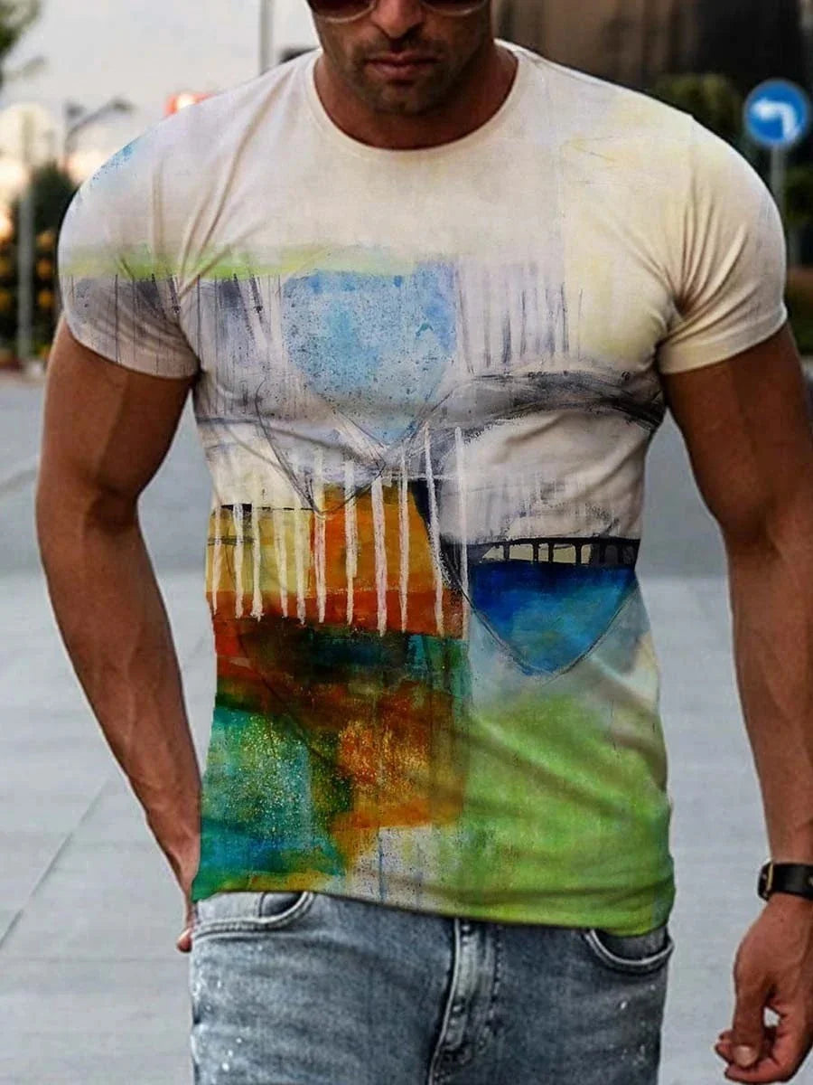 Muscular man wearing abstract art print t-shirt in urban outdoor setting, paired with light denim jeans