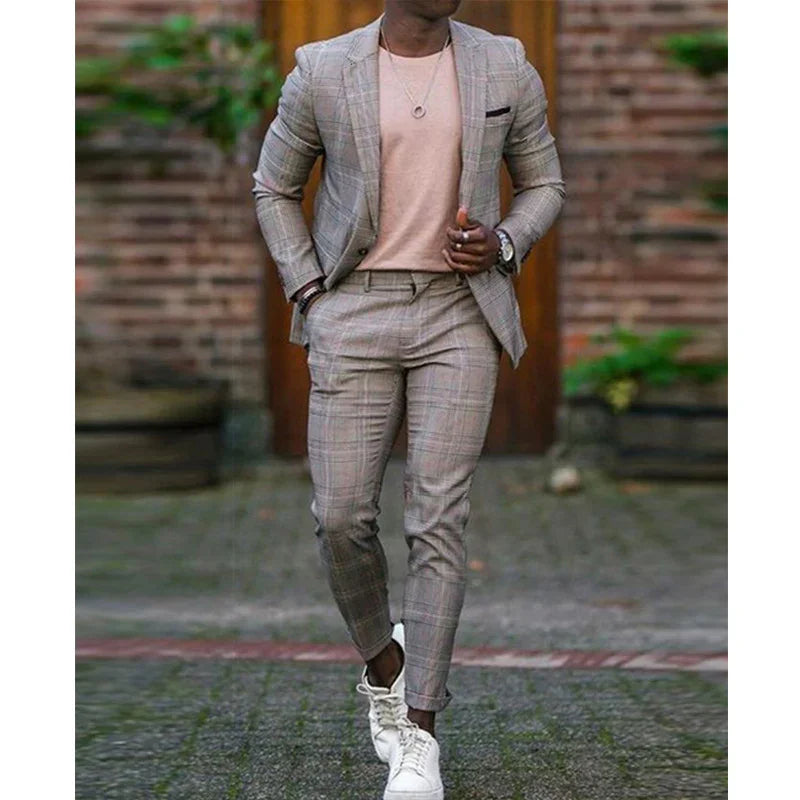 Man wearing slim fit checkered suit with peach shirt and white sneakers walking outdoors