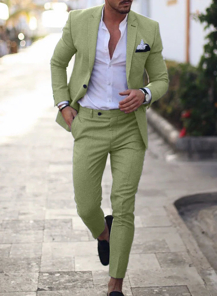 Stylish man walking outdoors wearing light green suit with white shirt and black loafers