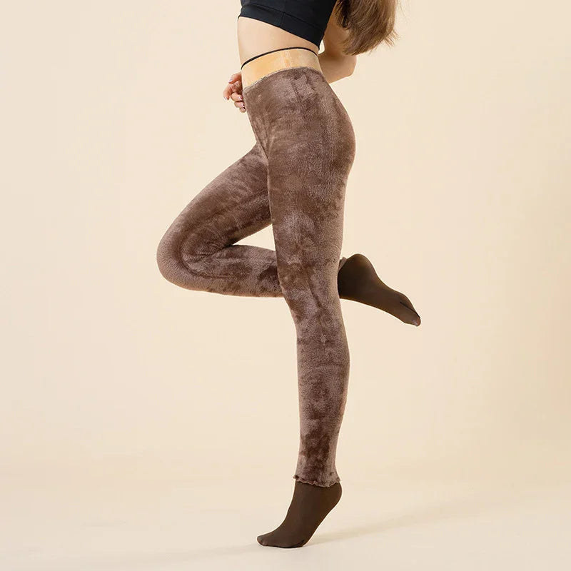 Woman wearing soft brown velvet leggings and black crop top against beige background