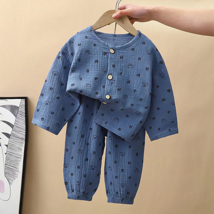 Blue baby outfit with bear and letter print, buttoned top and elastic cuff pants on hanger