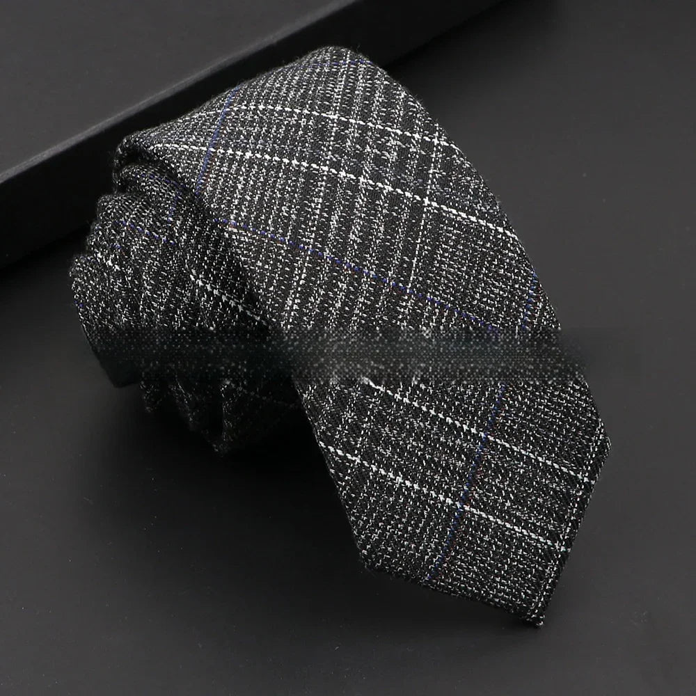 Black and gray checkered men's necktie with subtle blue lines on black background