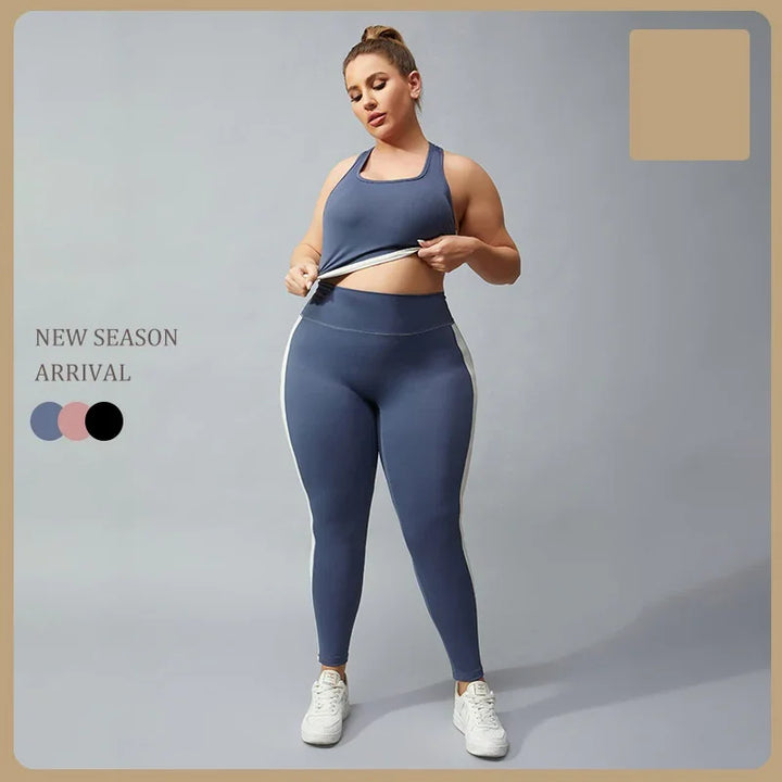 Plus size woman modeling blue athletic leggings and tank top with white sneakers on gray background
