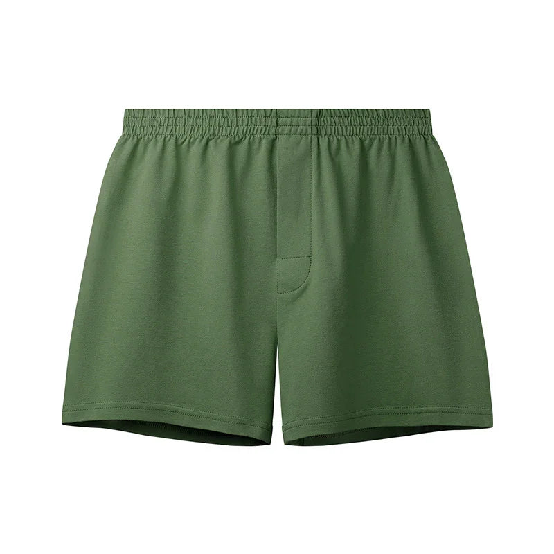 Plain green men's cotton boxer shorts with elastic waistband and fly front