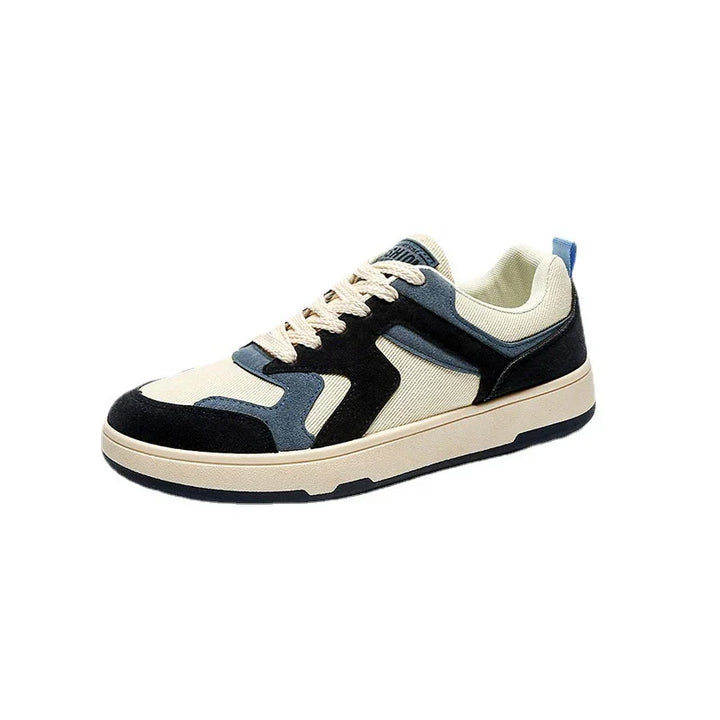 Casual sneaker with beige fabric and black and blue suede overlays, white laces, and a rubber sole