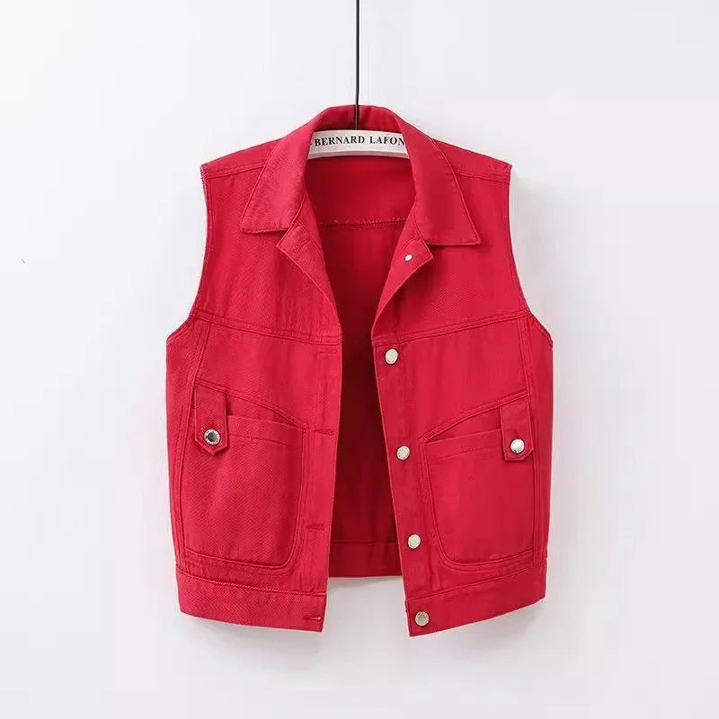 Red sleeveless denim vest with silver buttons and front pockets on a hanger