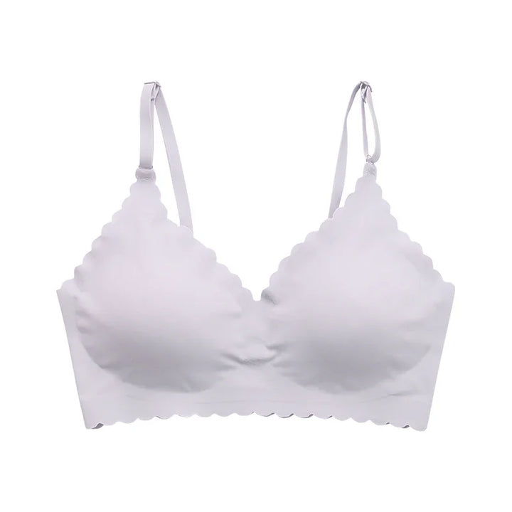White scalloped edge wireless bra with adjustable straps on white background