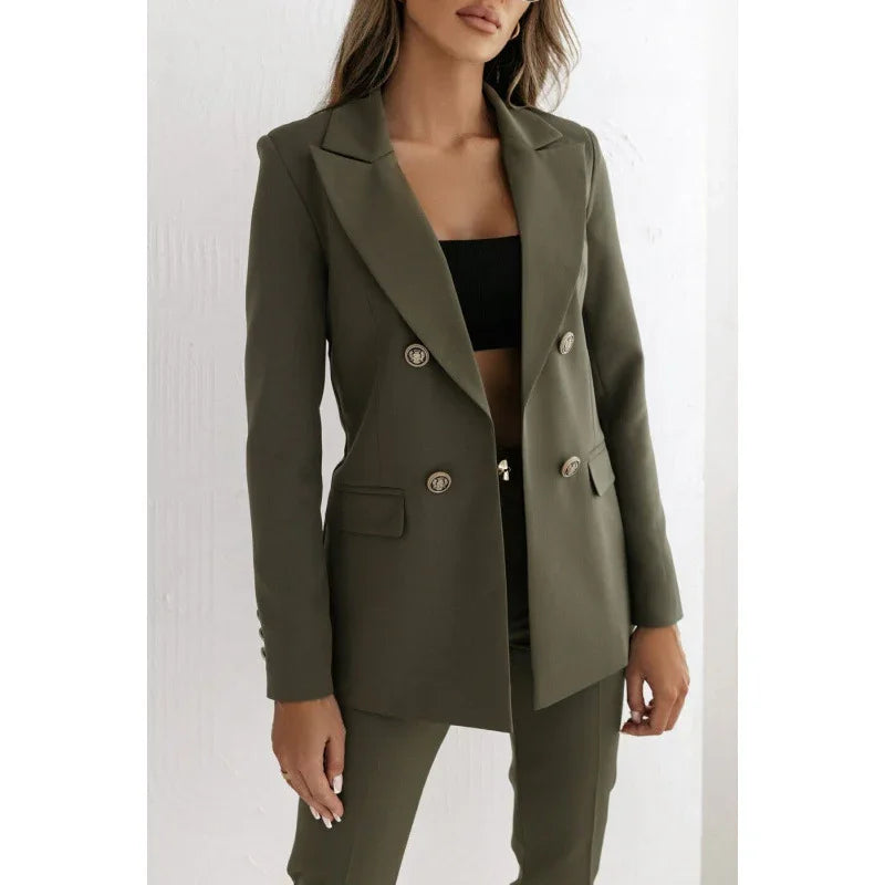 Woman wearing olive green double-breasted blazer and matching trousers, black crop top