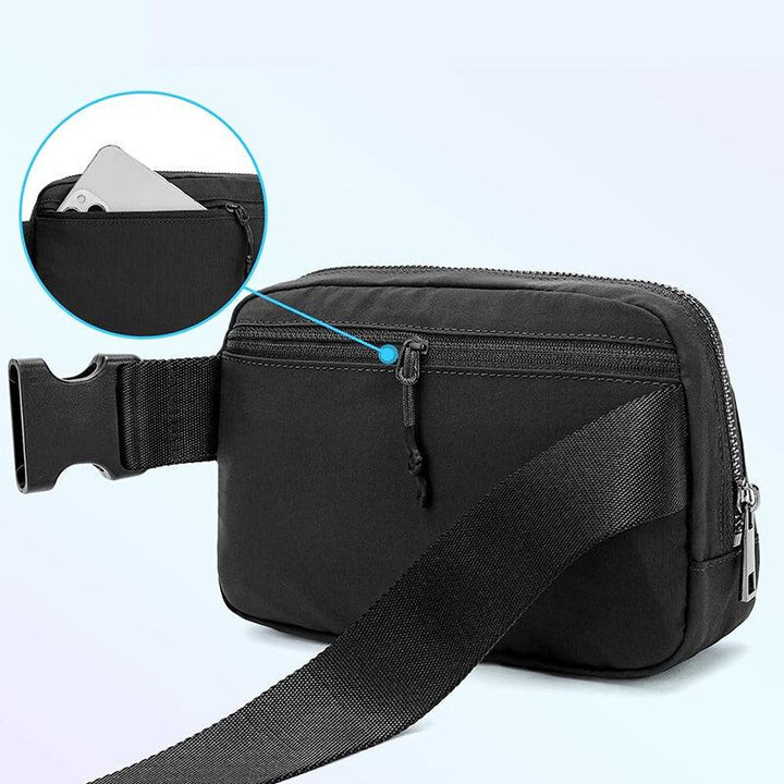 Black waist bag with adjustable strap and zippered front pocket holding a smartphone