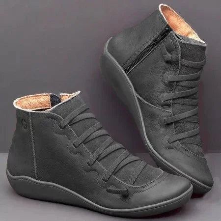 Black high-top casual shoes with side zipper and lace-up design on a gray background