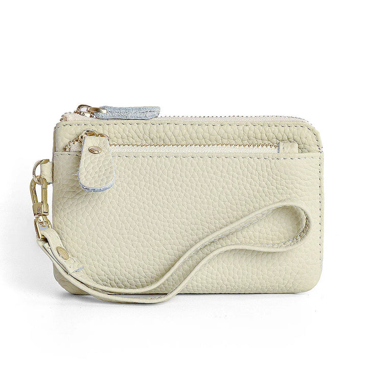 Light beige pebbled leather wristlet wallet with gold zipper and detachable strap