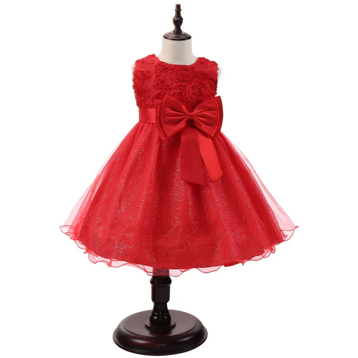 Red toddler girl's sleeveless dress with floral bodice, large bow, and glitter tulle skirt on mannequin