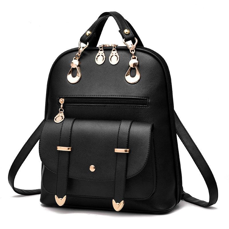 Black leather backpack with gold hardware, front pocket, zipper, and dual handles on white background